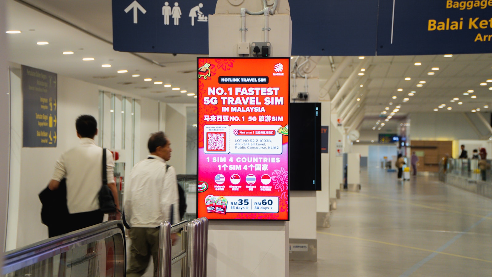 Digital advertising screen inside an airport concourse
